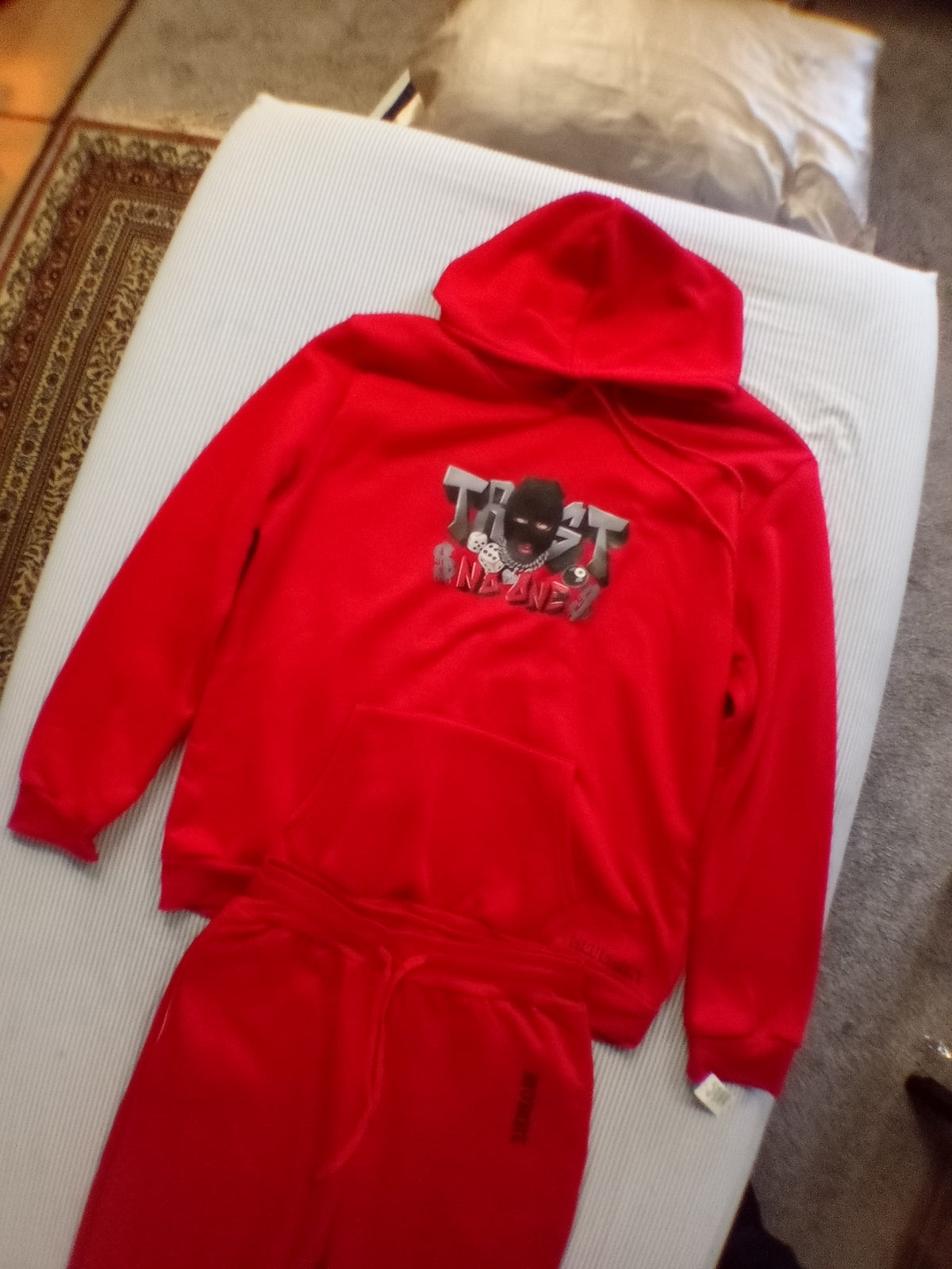 Red trust no one track suit