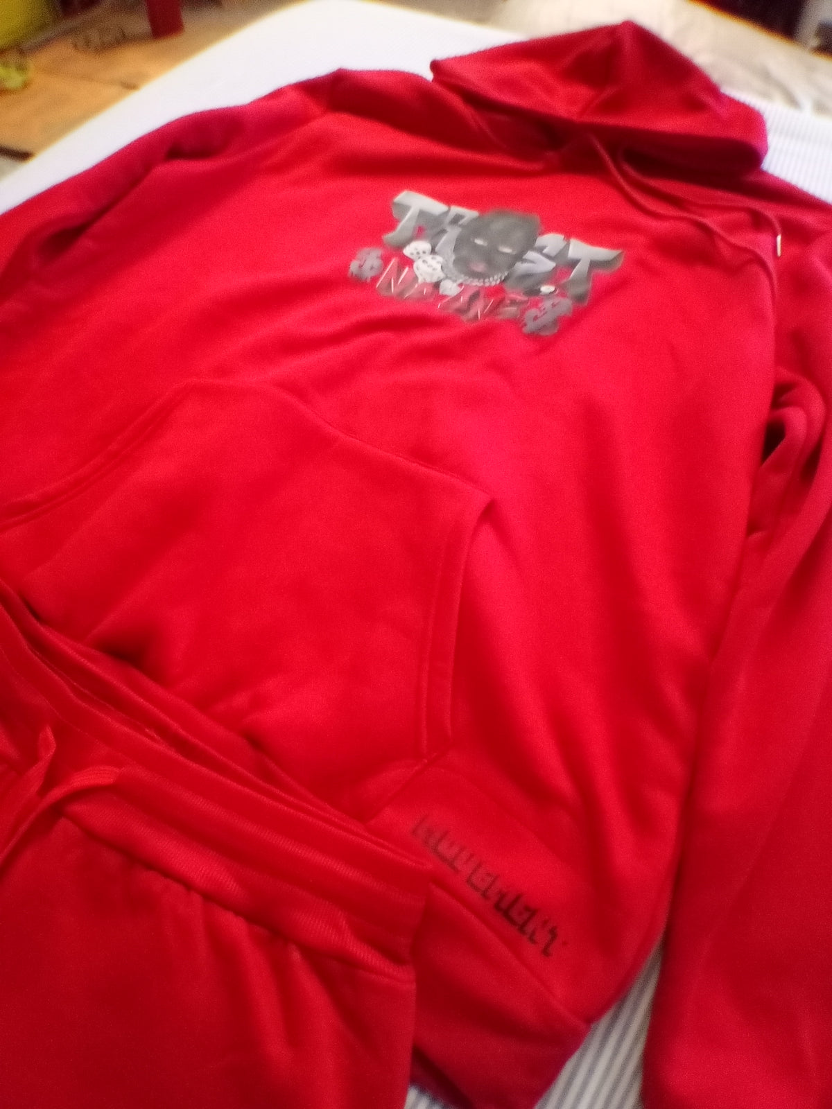 Red trust no one track suit